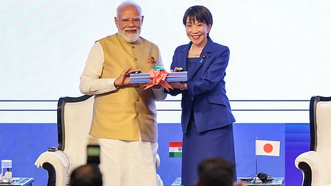 In the image PM Modi is shown with Sunae Takaichi