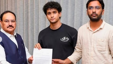 Image of CJP spokesperson Saurav das and Ashutosh Ranka meeting JP Nadda. they are holding a sheet of paper in the image. 