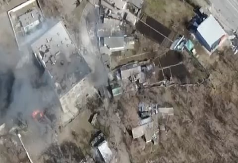 Images of Ukrainian air attack on Russian troops in Mariupol. The image is aerial view of the site with fumes coming out of the buildings.