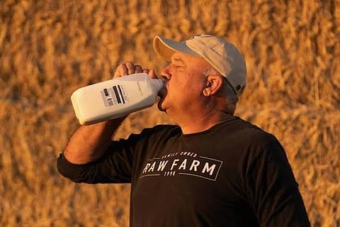 In the image Mark McAfee is shown drinking milk