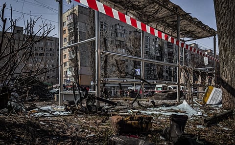 A demolished bus stop in Kyiv, Ukraine, showcasing signs of conflict and devastation.

