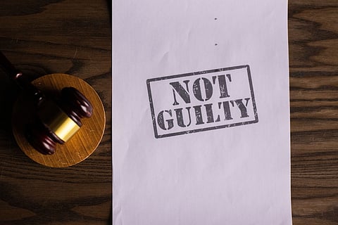 In the image court hammer and not guilty is shown