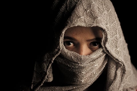 Woman wearing a head scarf in Tajikistan amid government restrictions