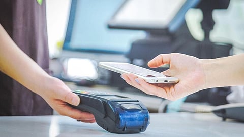 Image of two people carrying out a payment process in the modern era through qr code etc