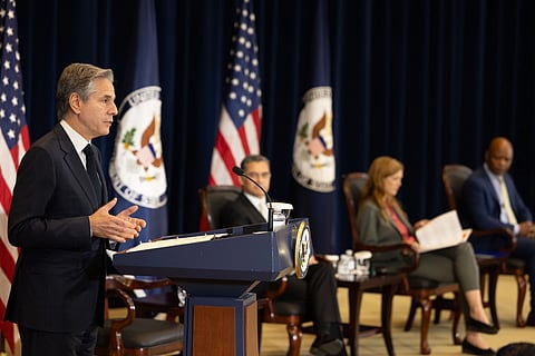 The image shows Becerra giving speech from podium some other dignitaries sitting beside him.