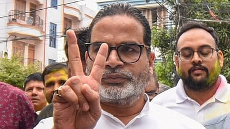 In the image prashant kishor is shown showing a victory sigh with his finger