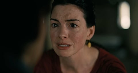 A Still from Christopher Nolan's The Odyssey. in the image Anne Hathaway can be seen in a closeup speaking to Tom Holland. 