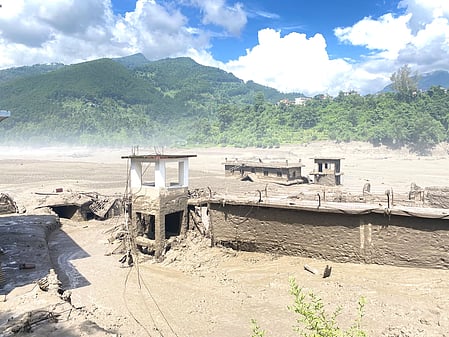 Image from the Nepal flash floods, an entire building is submerged in flood water and the  mudslide.