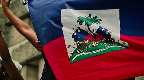 Protesters in Montreal holding Haitian flag and signs advocating for racial justice.