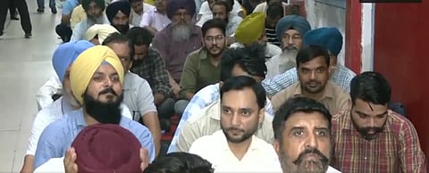 A group of men sitting in protest.