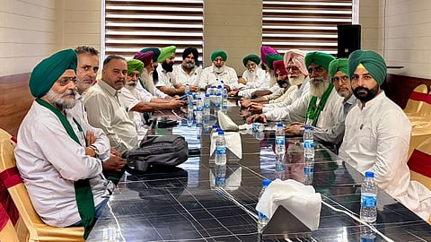 In the image SKM leaders are shown in a meeting