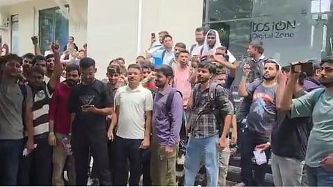 A group of men standing together and are engaged in an intense activity.