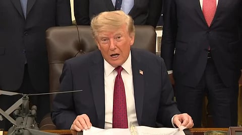 Donald trump sitting and addressing