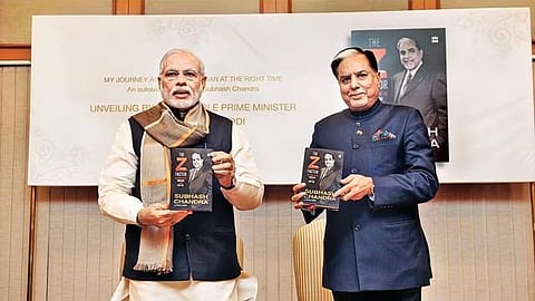 Two men holding books in their hand.