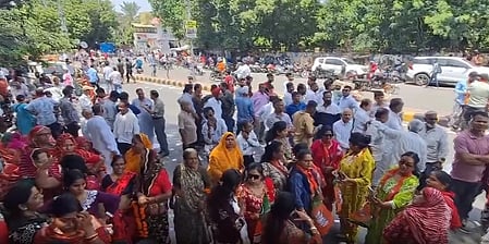 In the image many people are shown standing on a street of Rajasthan