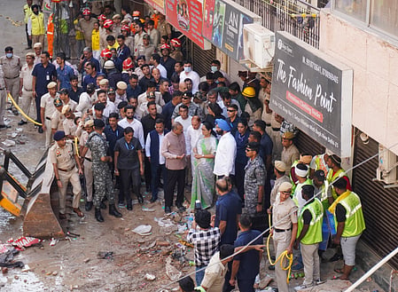 In the image many people are shown gathered outside a building