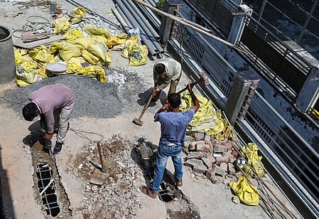 Labourers are shown demolishing building