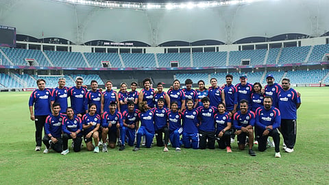 A group of sportsperson looking at the camera.