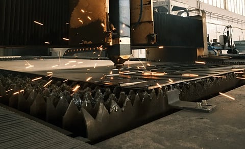 High-tech laser cutter operating in a modern industrial environment.

