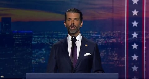 A Man wearing a blue suit speaking. 