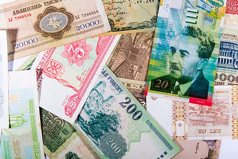 Foreign currency notes and a travel itinerary, representing forex planning for international travel