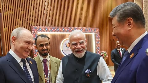 A group of four men laughing and smiling among themselves