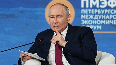 Russian President Vladimir Putin speaking into the mic.