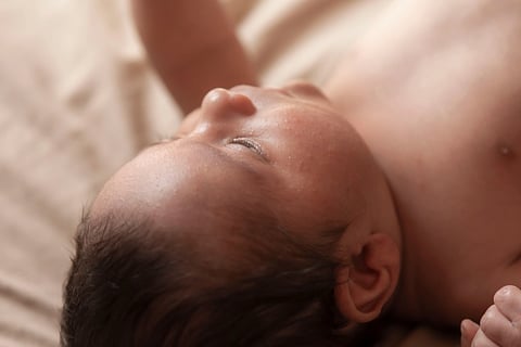 Serene close-up of a peaceful sleeping newborn baby, capturing innocence and tranquility.