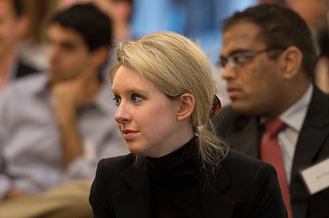Elizabeth Holmes, the chief executive officer and founder of Theranos, a health care technology company, listens as Deputy Secretary of Defense Ash Carter speaks at Stanford University in Palo Alto, Calif., April 17, 2013.