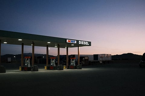 Gas station price board showing high diesel and gasoline prices