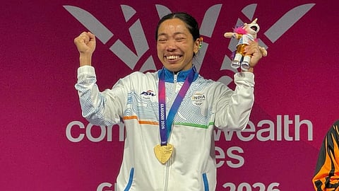 A woman celebrating after winning a medal.