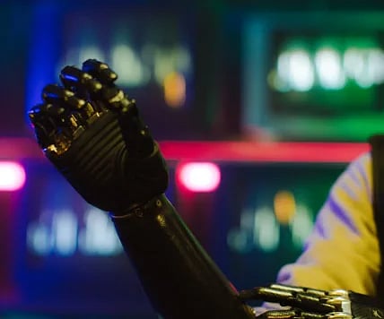 Close-up of a cybernetic prosthetic arm with chrome detailing under vibrant neon lights, conveying a cyberpunk theme.
