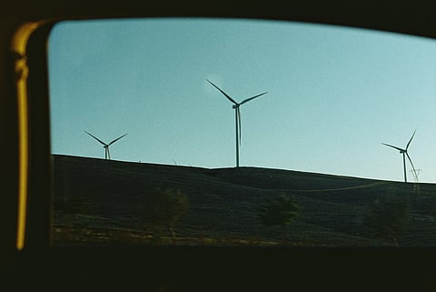 Solar panels and wind turbines highlighting growth in US renewable energy capacity
