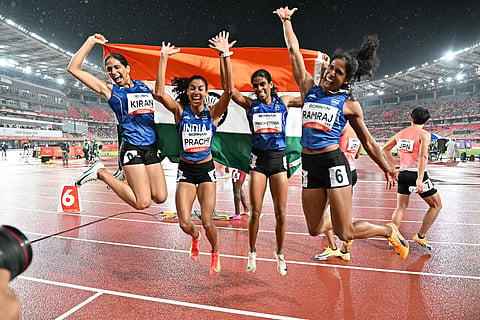 A group of four women athlete celebrating