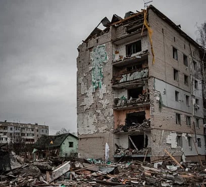 A severely damaged residential building in Borodyanka, Ukraine amid rubble and destruction.
