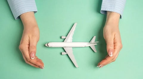 image of two hands protecting a toy  airplane