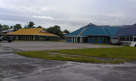 On the left (yellow roof) we have a maneapa, and on the right is the Funafuti (FUN) airport terminal.