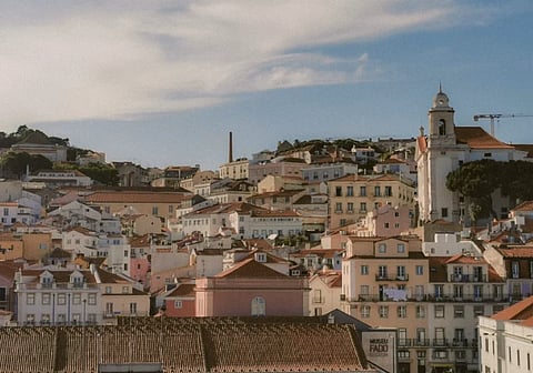 Aerial view of Lisbon's charming historic architecture under a bright sky.
