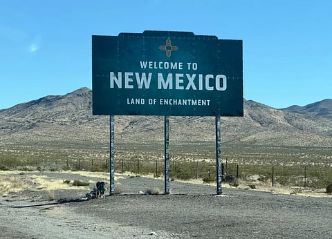Image of Iconic welcome sign for New Mexico in a desert landscape, tracing the state's enchanting charm.
