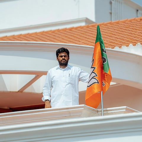 Annamalai with the flag of the BJP during the foundation  day of the party 
