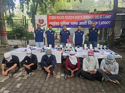 In the image police is shown with criminals covering their faces