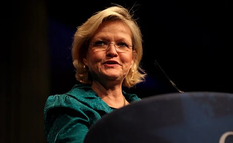 Image of Cleta Mitchell speaking at the 2012 CPAC in Washington, D.C. the background is darker and mitchell is standing in front of a podium