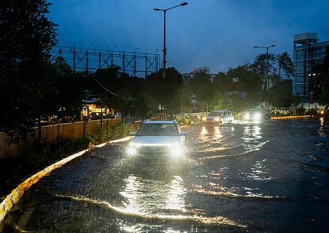 a car is navigating through the Cyclone Arnab borne flooding