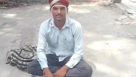Rural Maharashtra man sitting on ground wearing a wedding turban 