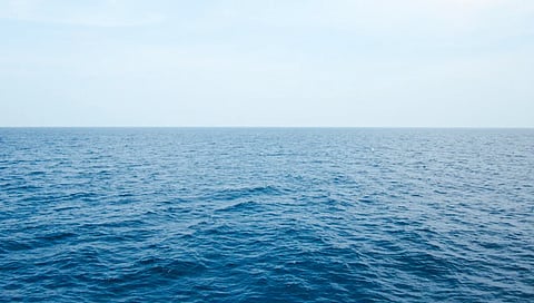 Peaceful ocean view under a clear blue sky in the Andaman sea, India.
