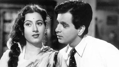 Black and white image of Madhubala and Dilip Kumar who is looking at her. 