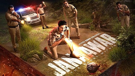 तीन पुलिस ऑफिसर है जिस में एक बैठा है और उसके हाथो में टोर्च है 