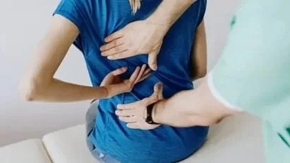 पीठ दर्द से परेशान लड़की की तस्वीर|