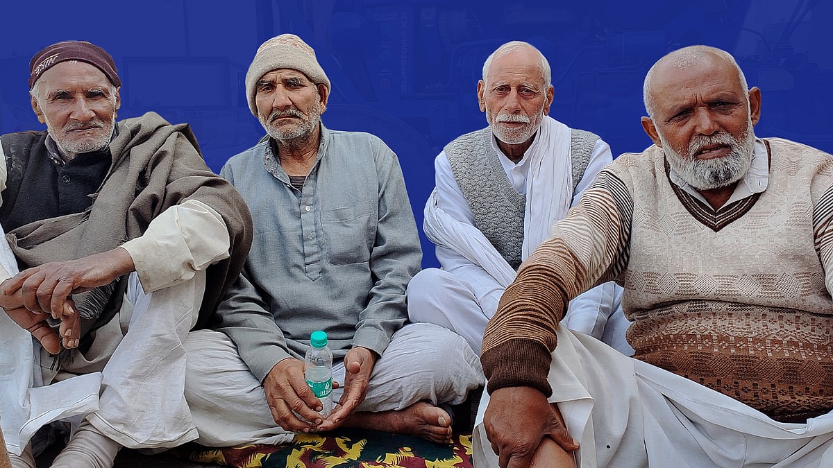 Rampal Singh (extreme left) sits with other men from his village at Ghazipur.