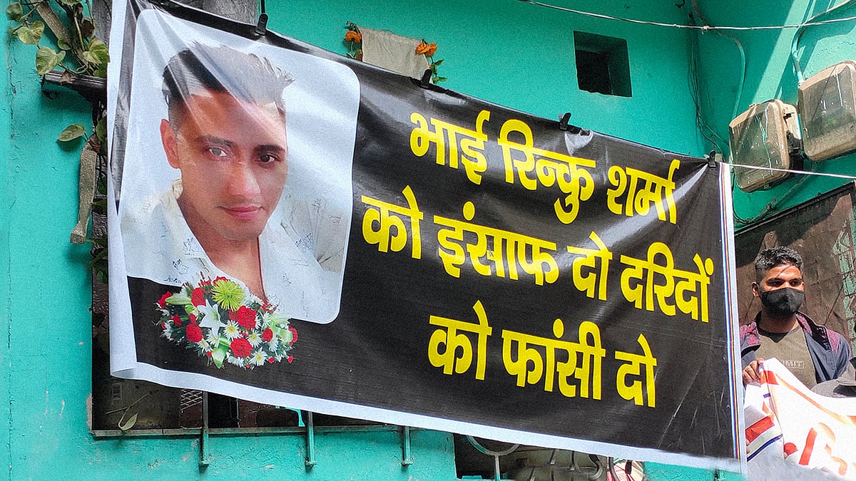 A banner of Rinku Sharma near his home.